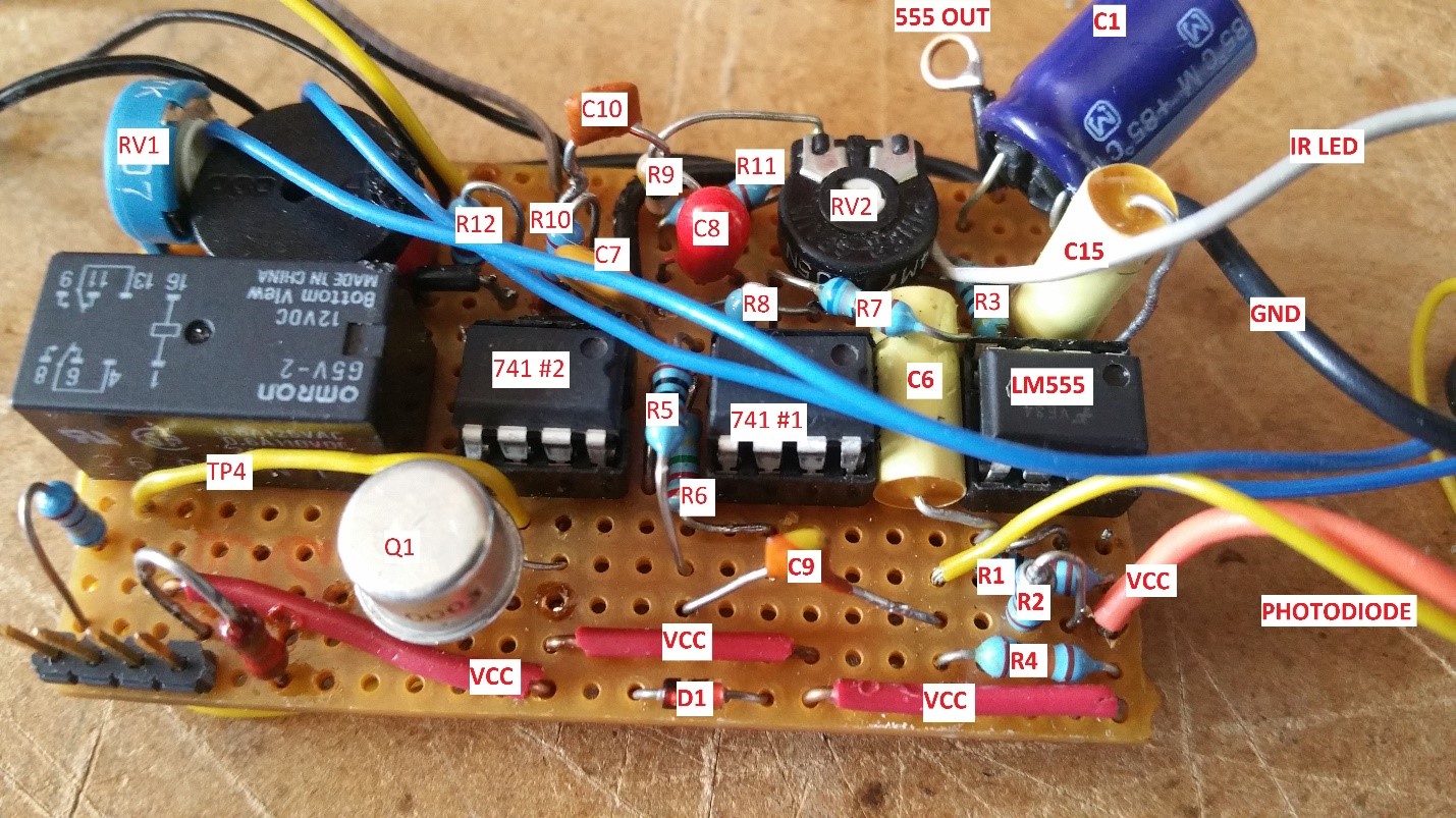 Analogue blink sensor PCB showing 555 timer IC, IR LED, IR photodiode, op-amps, and other circuit components labeled on the board.